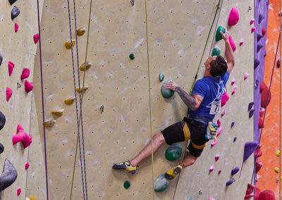 male participant climbing a wall