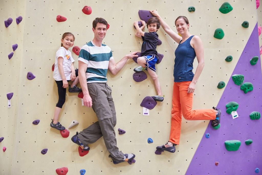 A family posing together on the climbing wall