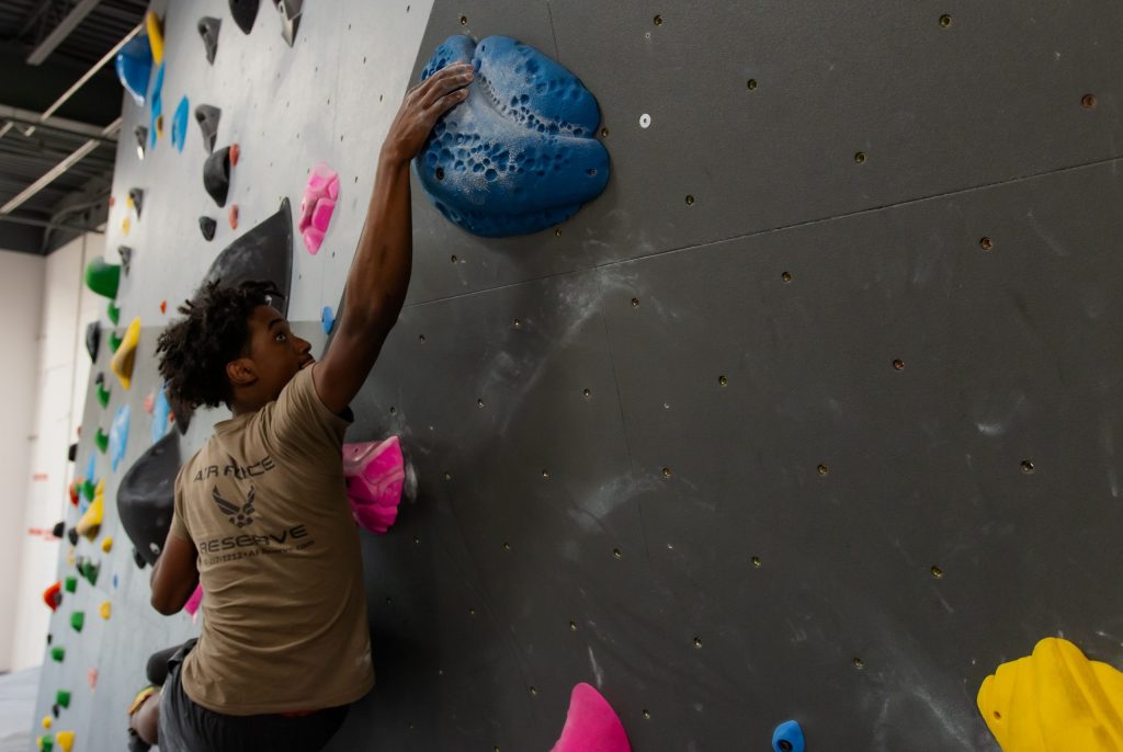 A climber reaching for a hold