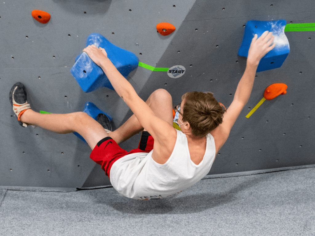 man climbing in an indoor climbing gym
