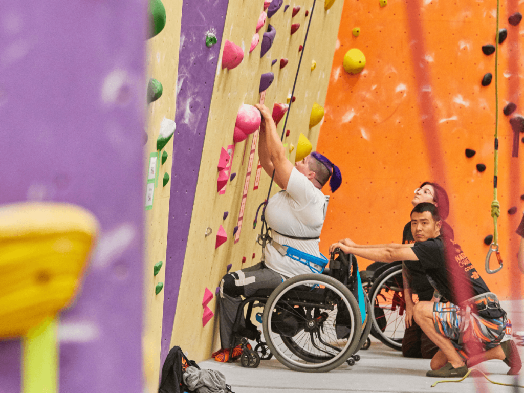 adaptive climber climbing a wall