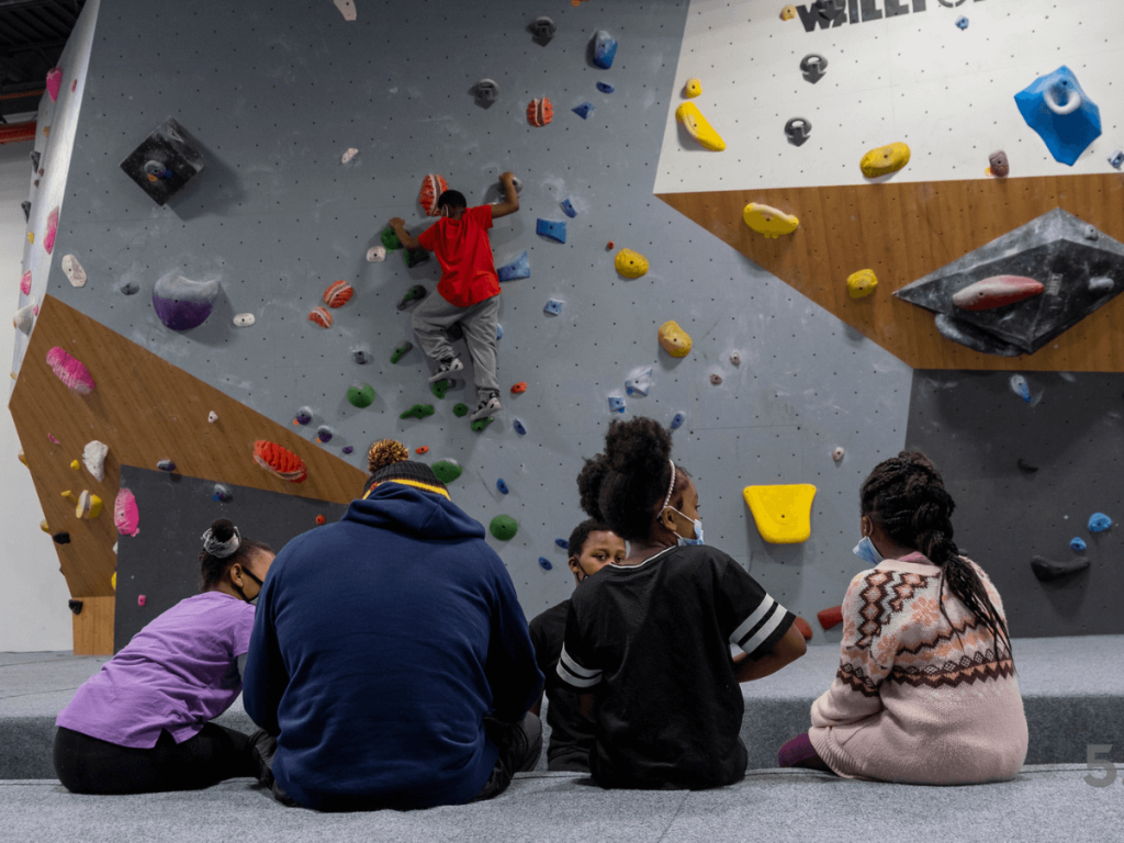 kids in an indoor rock climbing gym