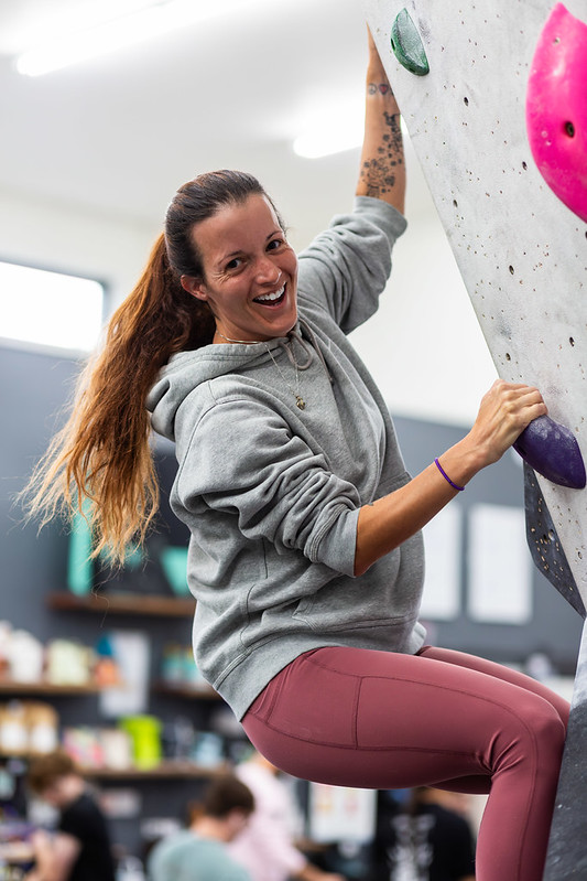Climber smiling on the bouldering wall at Chambers