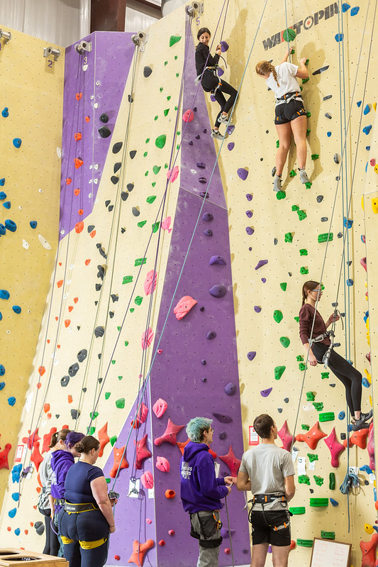 Climbers on top rope on the tall walls at Vertical Adventures